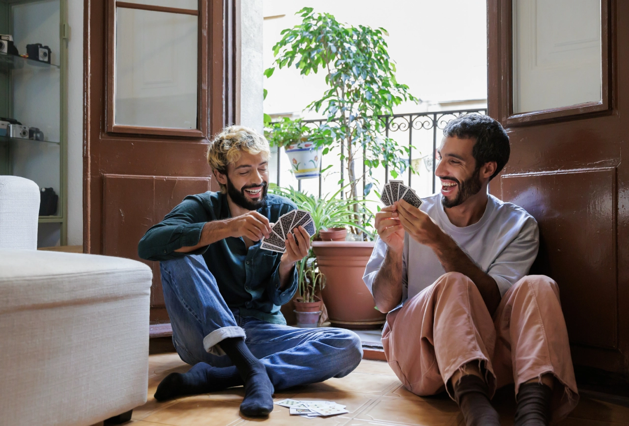 Friends playing cards on the floor