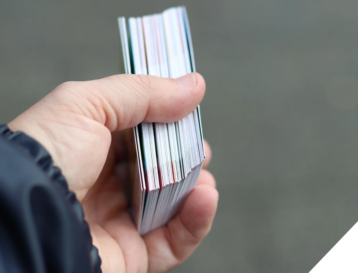Close-up of hand with stacked cards